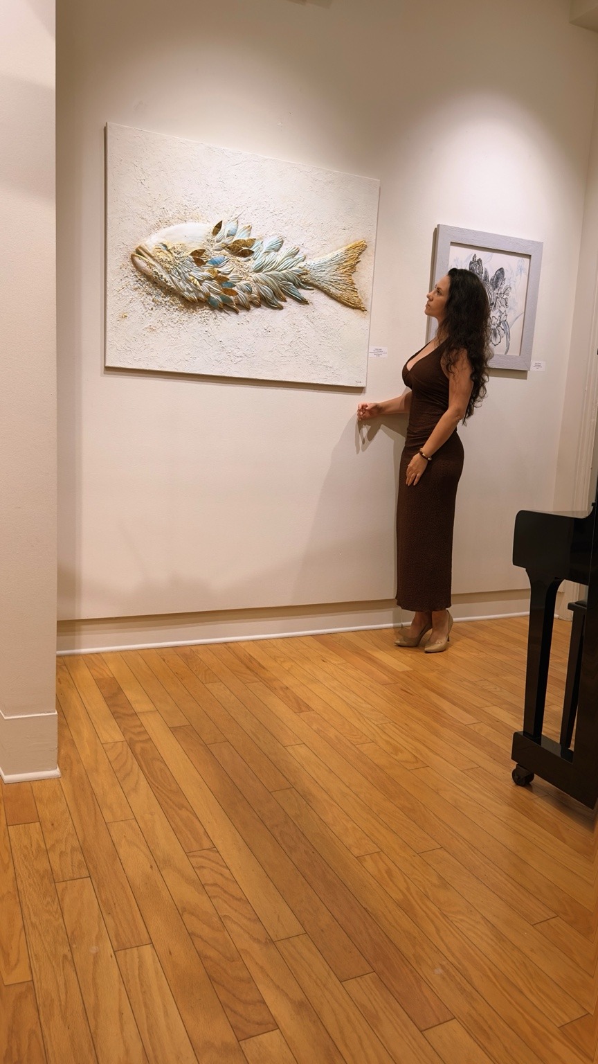 Liubov Untila with Fish of Abundance at a gallery exhibition
